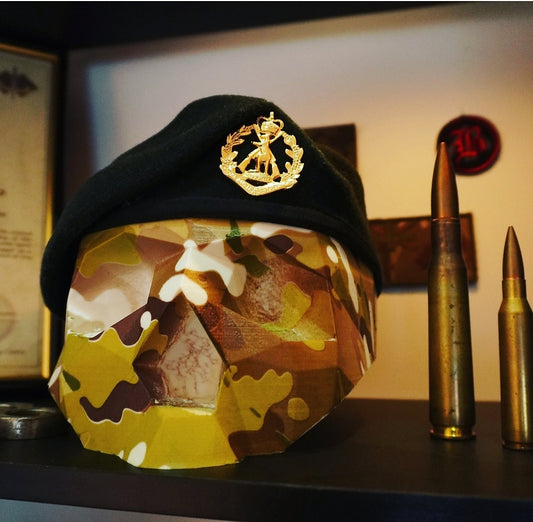 Green beret on camouflage skull display